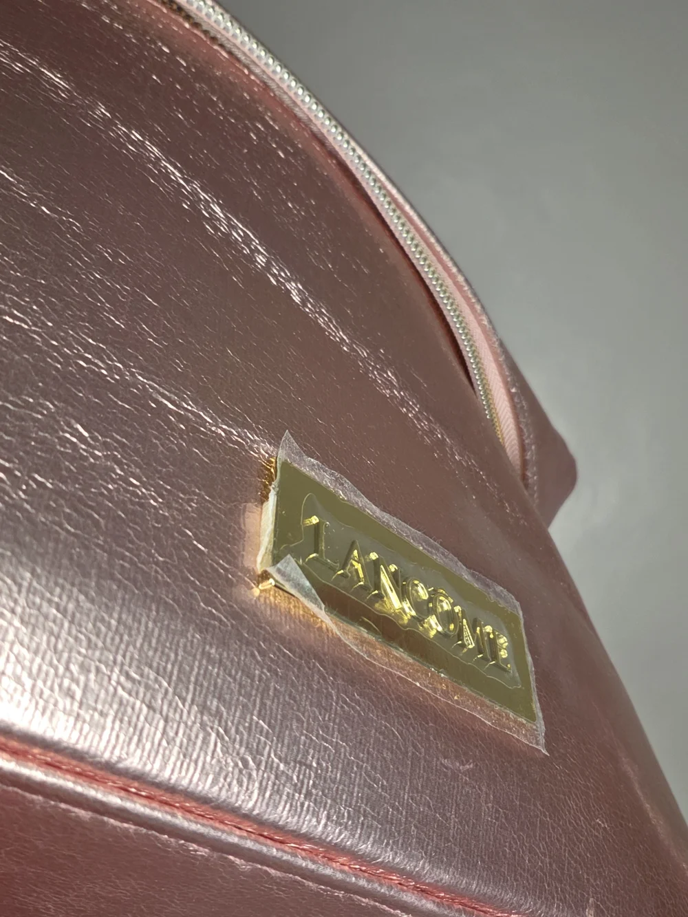 Lancome cute travel case for metallic pink makeup along with a palette of neutra